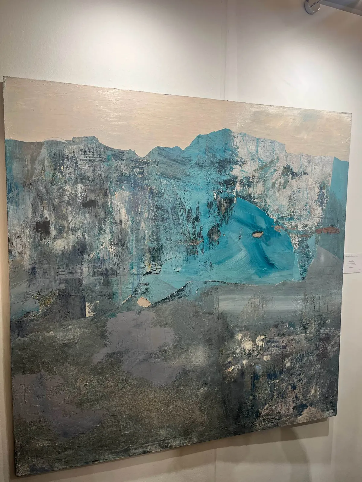 Close-up view of Blue Deviation Issue on the gallery wall at Chelsea Old Town Hall during the London Art Biennale 2023
